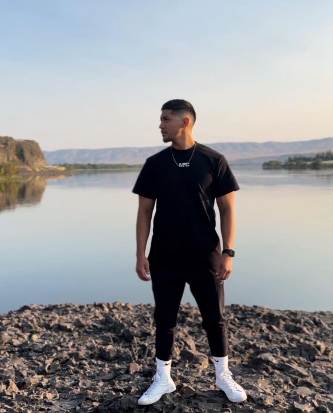 Ulises Sanchez standing by a lake